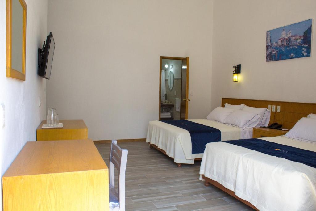 Postel nebo postele na pokoji v ubytování Hotel Real de Castilla Colonial