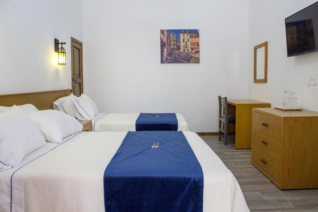 Postel nebo postele na pokoji v ubytování Hotel Real de Castilla Colonial