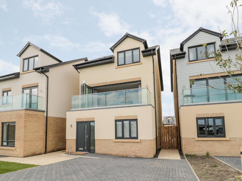 an image of a house with glass windows at Amble Views in Morpeth