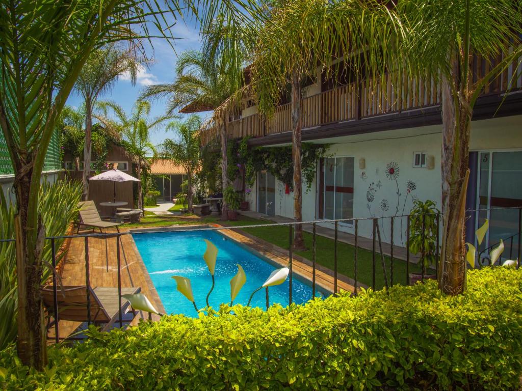 a swimming pool in front of a house at Hotel Villas Mariposas in Atlixco