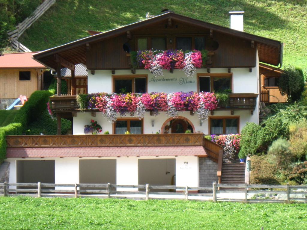 a house with flower boxes on the windows at Appartements-Klaus in Neustift im Stubaital