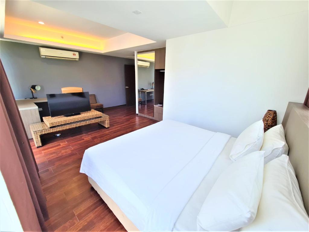 Postel nebo postele na pokoji v ubytování Nexus Business Suite Hotel