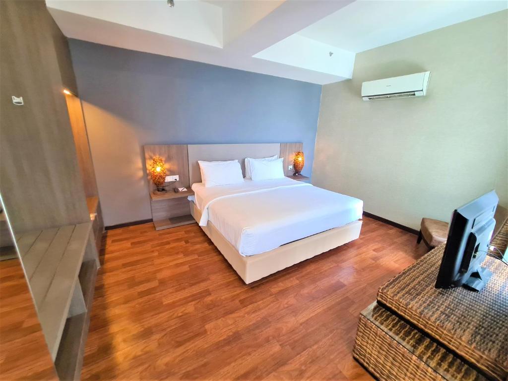Postel nebo postele na pokoji v ubytování Nexus Business Suite Hotel