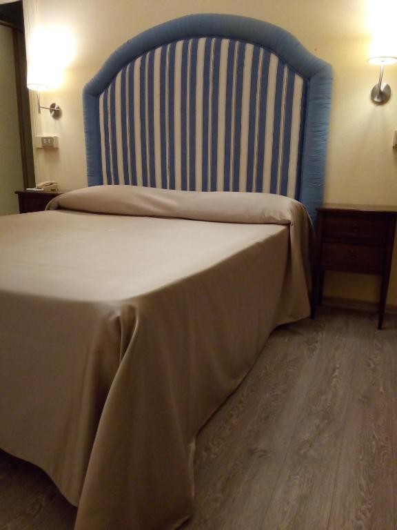 Postel nebo postele na pokoji v ubytování Hotel Stipino