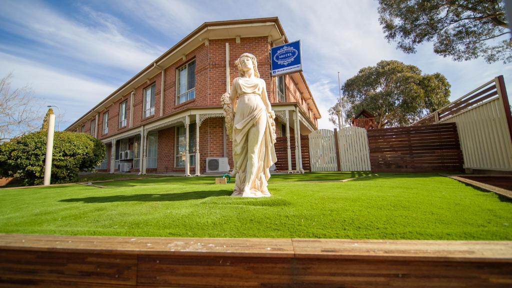 a statue of a woman in front of a building at Hamilton's Queanbeyan Motel in Queanbeyan