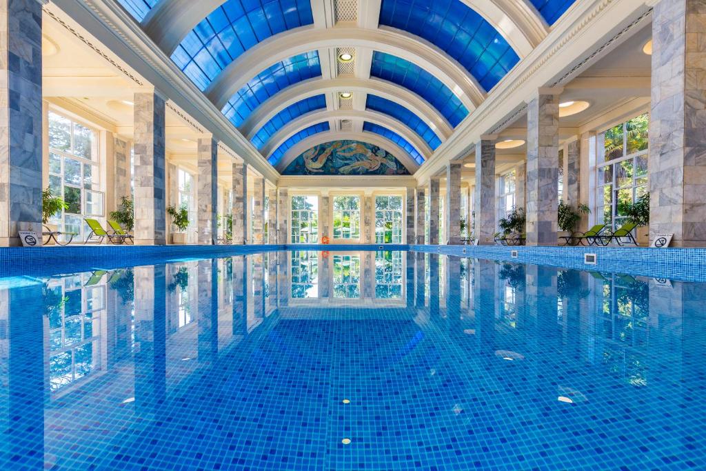 a swimming pool in a building with a ceiling at Metallurg Health Resort in Sochi