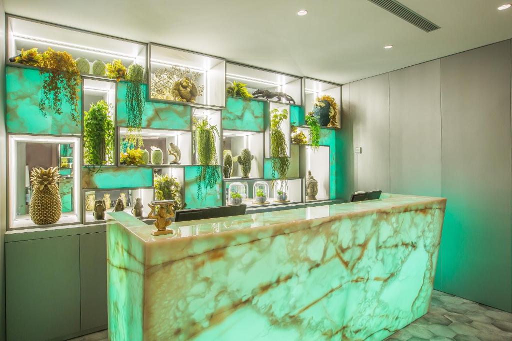 a lobby with a counter with a bunch of vases at Hotel Brö-Adults Recommended in Málaga