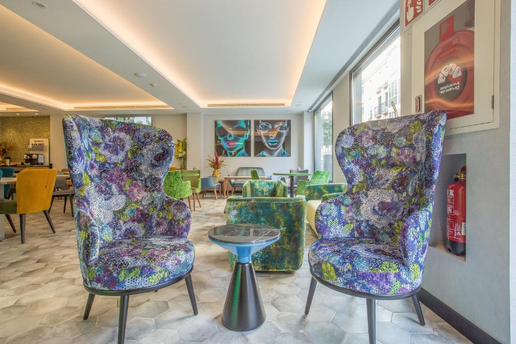 a lobby with two chairs and a table at Hotel Brö-Adults Recommended in Málaga
