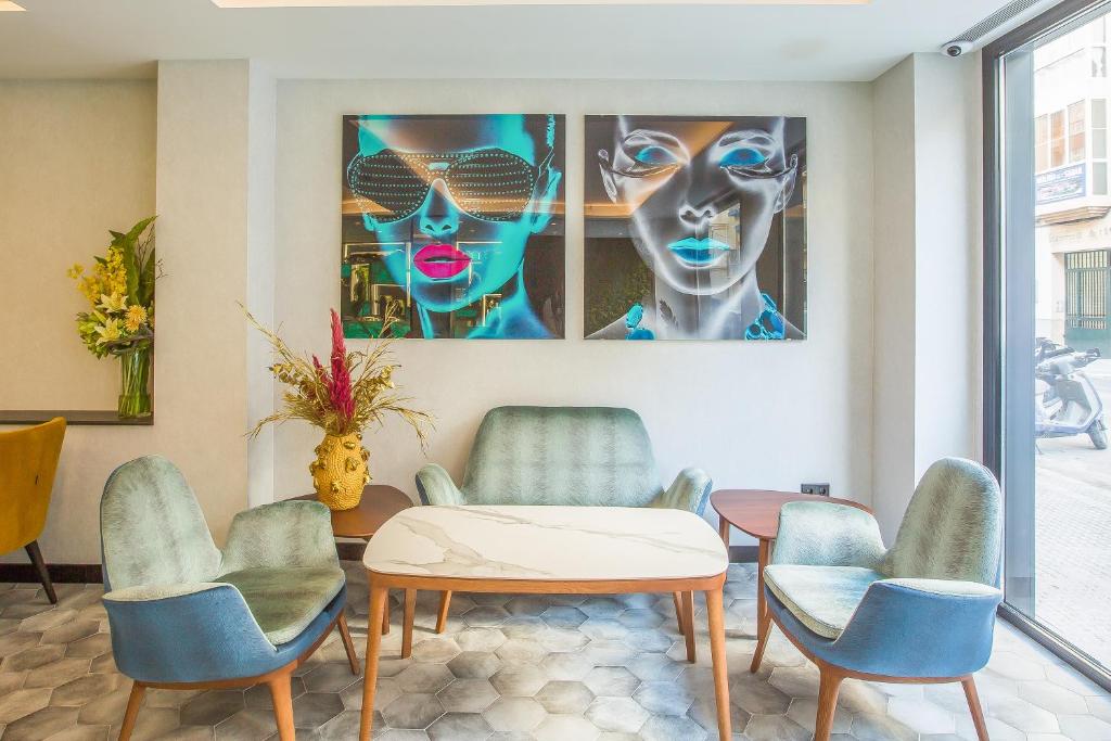 a room with a table and chairs and a painting at Hotel Brö-Adults Recommended in Málaga