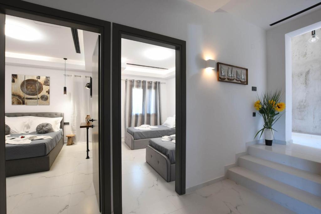 a living room with a couch and a mirror at Orion Eco Suites in Karteros
