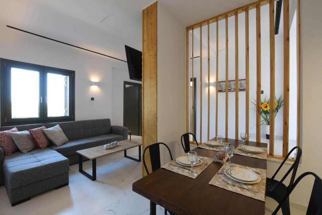 a living room with a couch and a table at Orion Eco Suites in Karteros