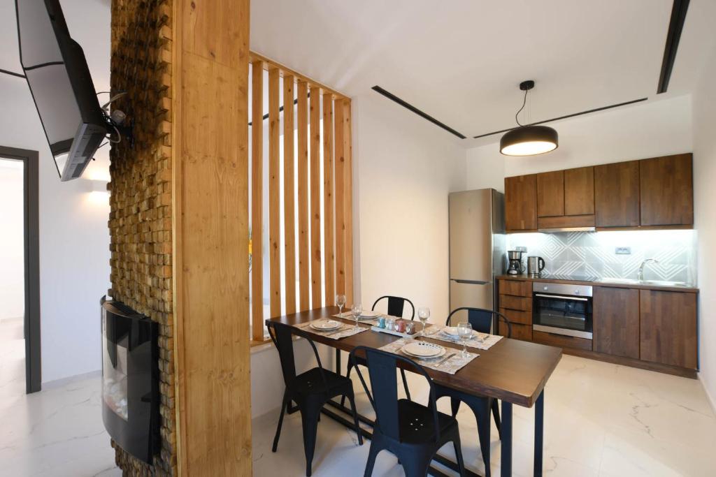 a kitchen and dining room with a table and chairs at Orion Eco Suites in Karteros