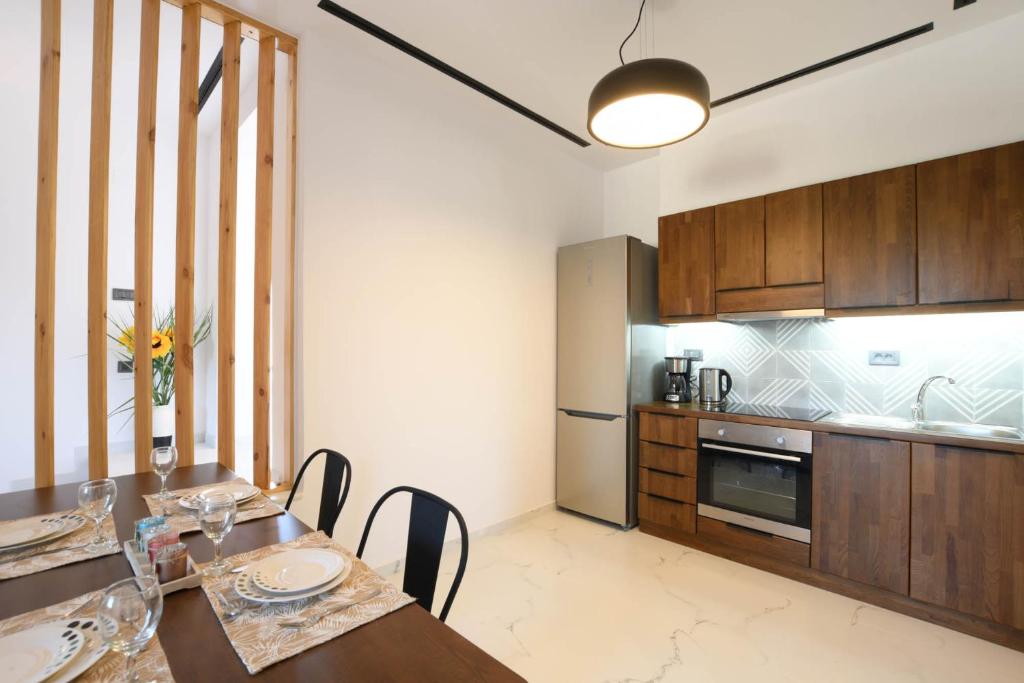 a kitchen with a table and chairs in a room at Orion Eco Suites in Karteros