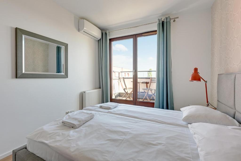 Posteľ alebo postele v izbe v ubytovaní GRANO FLATS Gdańsk - Chmielna 73