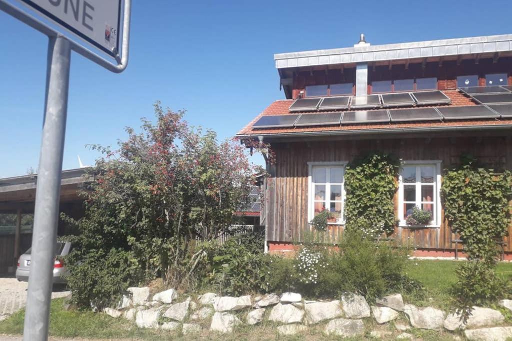 a house with solar panels on top of it at 2 Ferienhaus Andermichlhof in Geltendorf