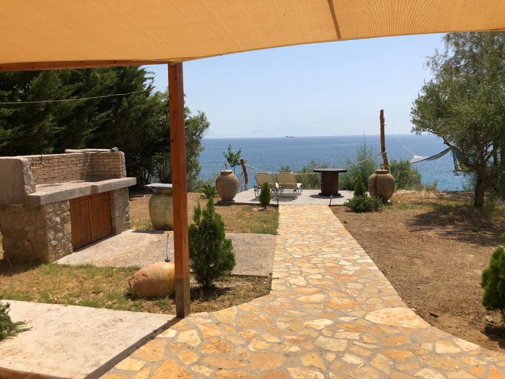 a stone walkway with a view of the ocean at Seafront Studio with direct beach access in Koroni
