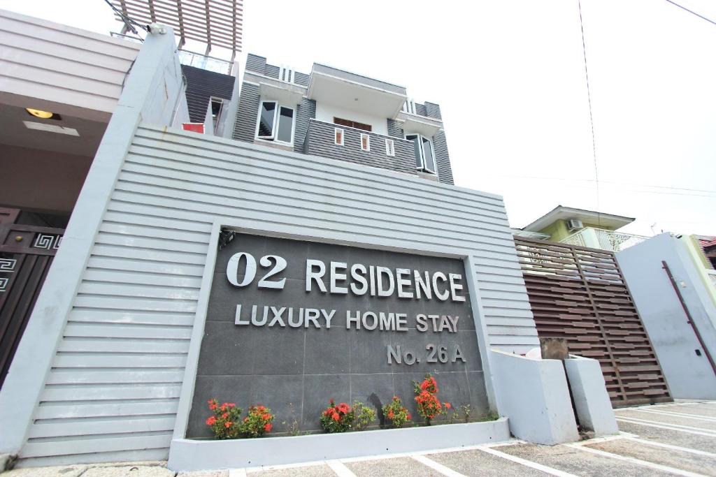 a building with a sign on the side of it at O2 Residence in Medan
