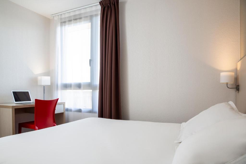 Postel nebo postele na pokoji v ubytování Aparthotel Adagio Access Avignon