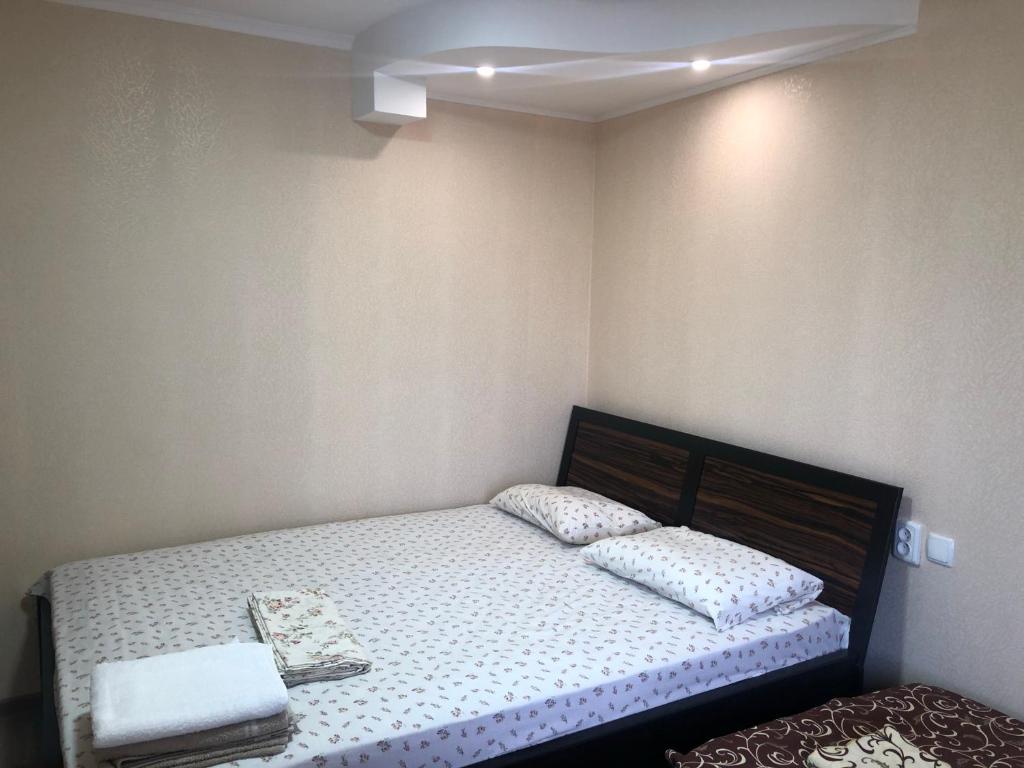 a small bedroom with a bed with two pillows at Гостиный Дом Comfort in Reni