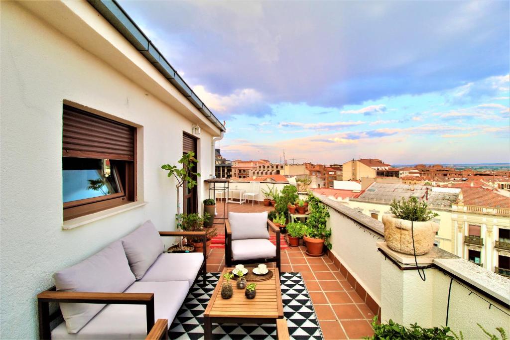 a balcony with a couch and a table at El Mirador de Zamora in Zamora