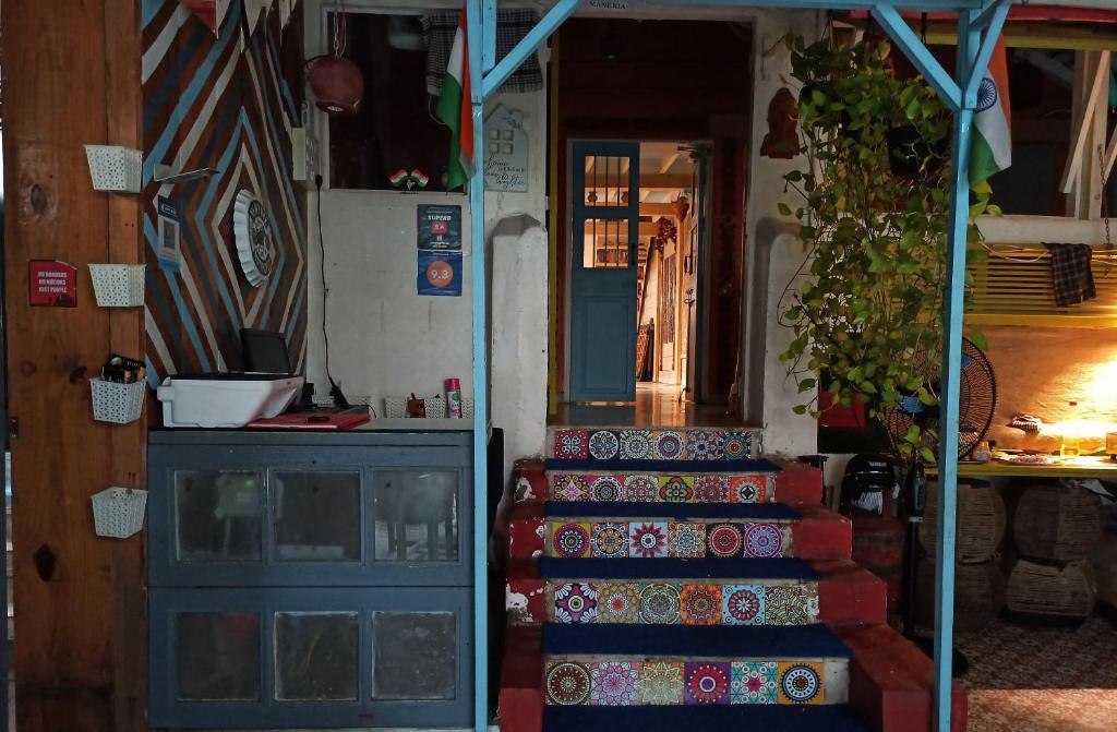 a staircase with a blue door next to a blue door at NAMASTEY MUMBAI BACKPACKERS in Mumbai