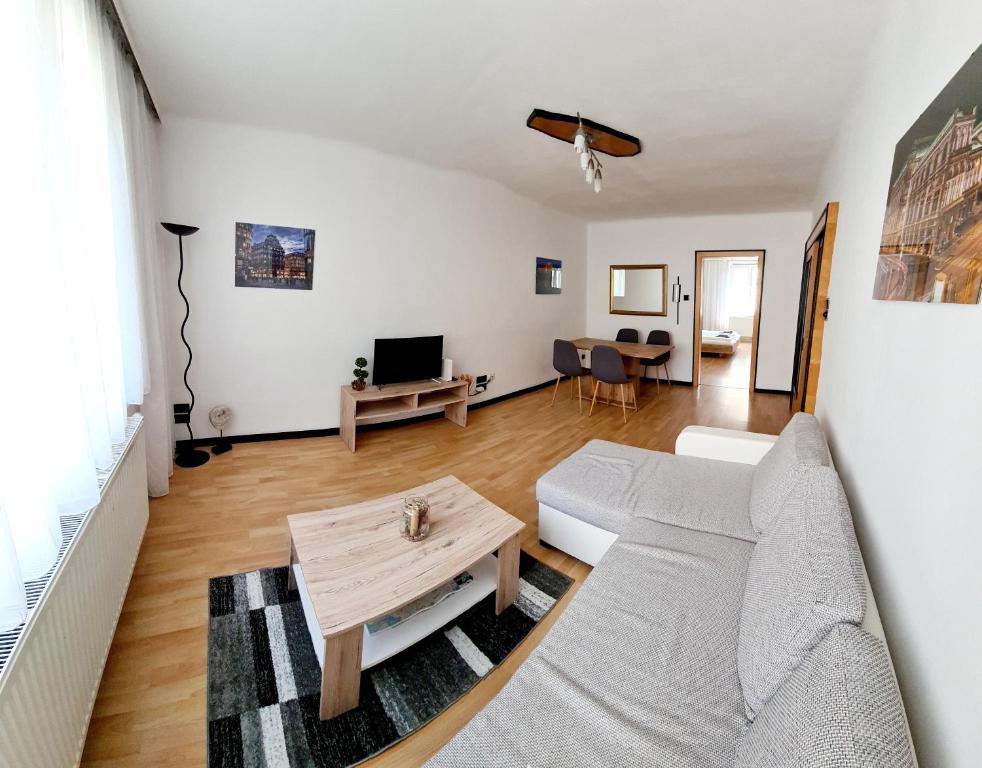 a living room with a couch and a table at Sunny Apartment in Vienna