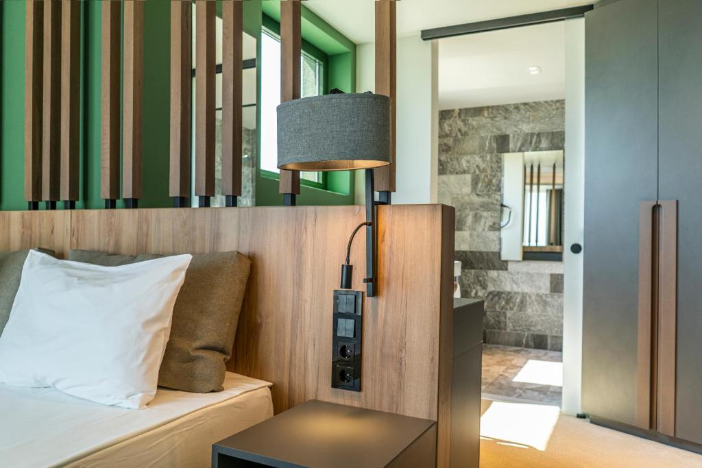 a bedroom with a bed and a table with a lamp at HVD Reina del Mar - Premium Spa Service & Free Parking in Obzor