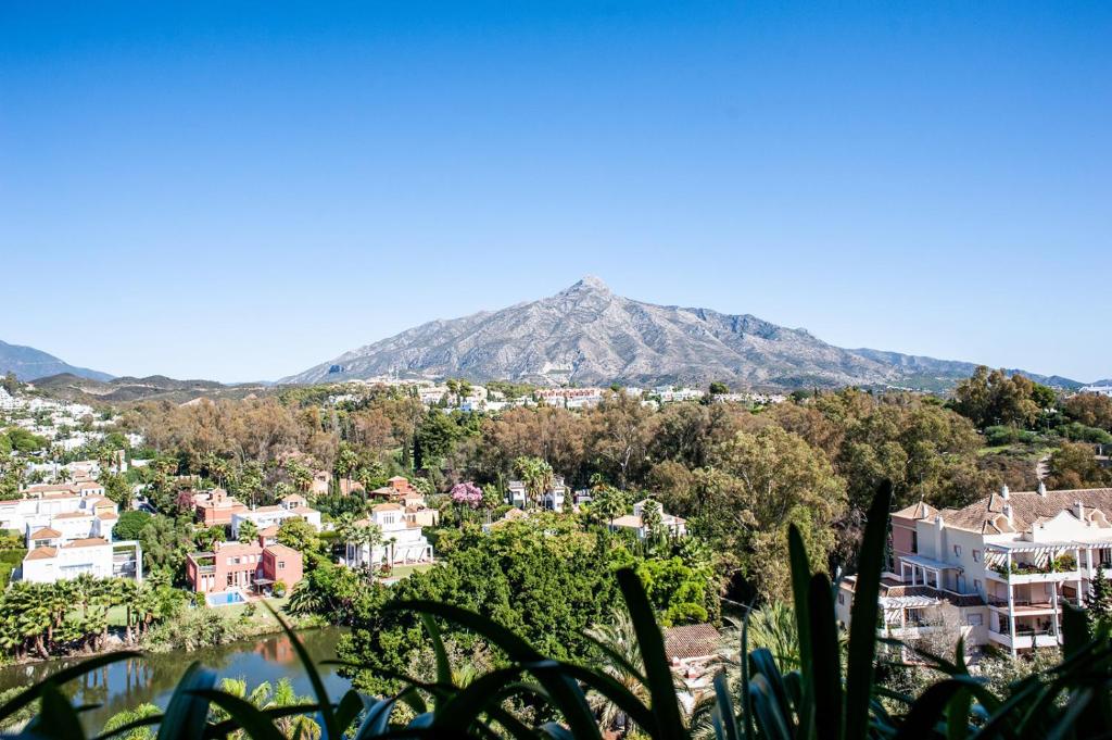 a view of a town and a mountain at Luxe Apartments Hotel del Golf - Las Brisas Marbella in Marbella