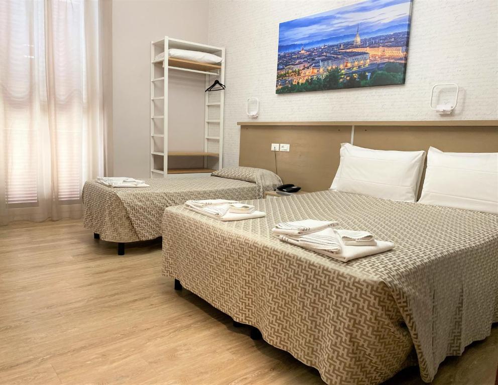 Postel nebo postele na pokoji v ubytování Hotel Lo Scudiero