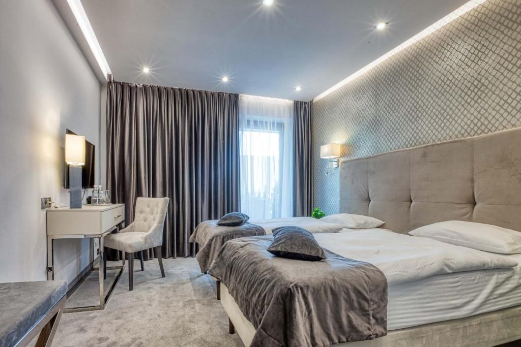 Postel nebo postele na pokoji v ubytování Hotel Biały Dom