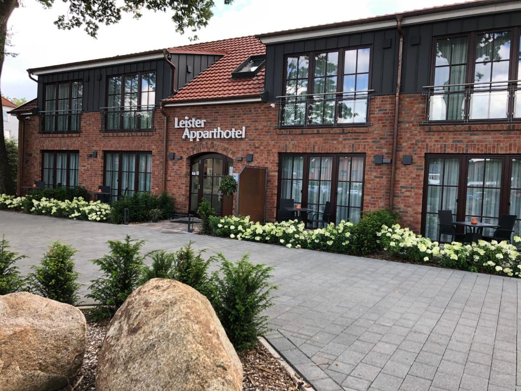 a brick building with a sign that reads leetter appartment at Leister Apparthotel in Weyhe