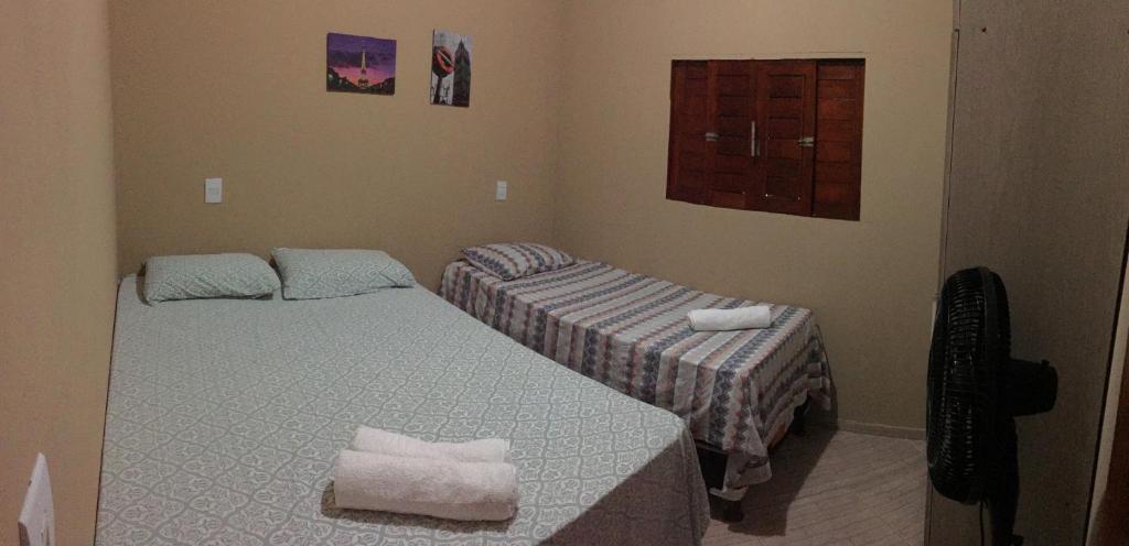 A bed or beds in a room at Residencial Sibaúma