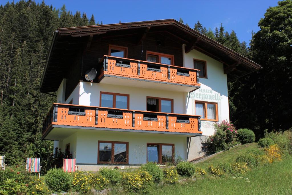 a house with orange balconies on top of it at Haus Bergquell in Ramsau am Dachstein