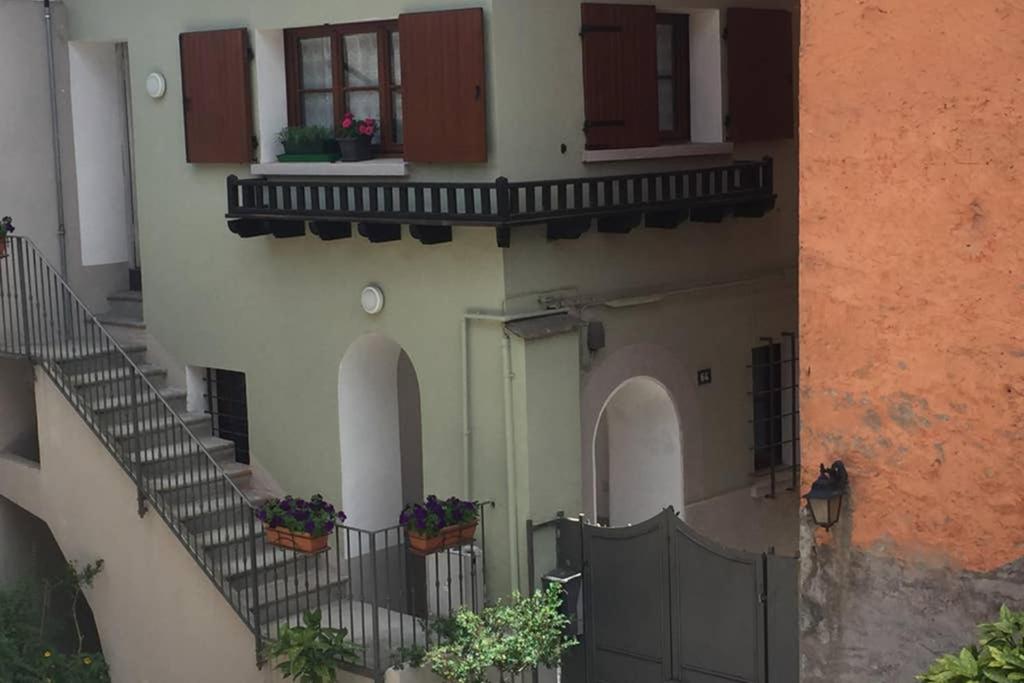 a building with stairs and windows with potted plants at Aubert 64 in Aosta