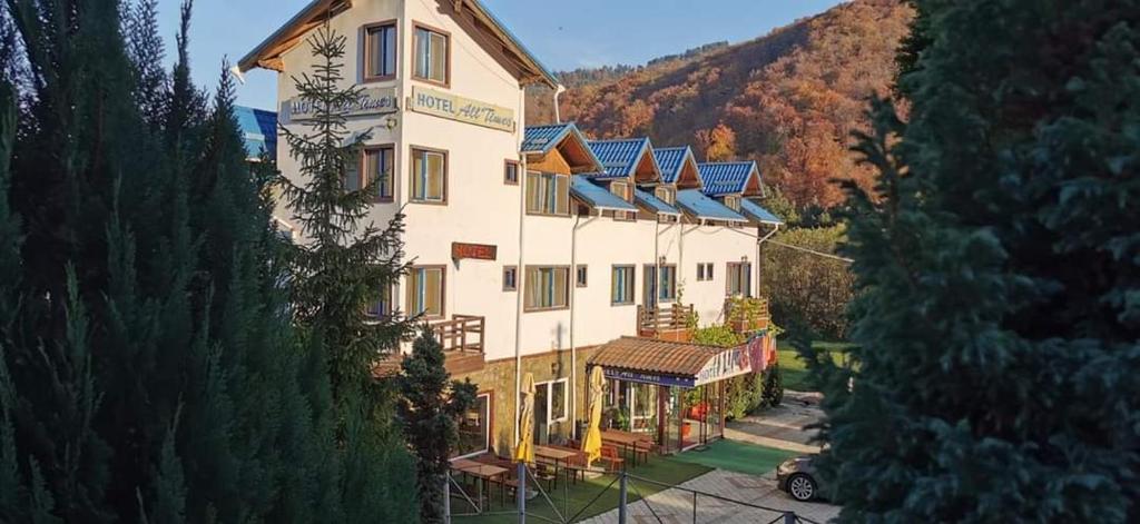 an aerial view of a large building with blue roofs at HOTEL ALL TIMES in Timisul de Jos