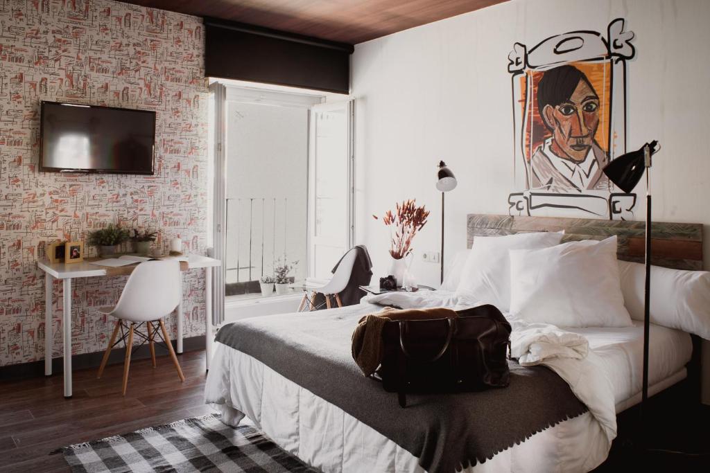 a bedroom with a bed with a bag on it at room007 Chueca Hostel in Madrid