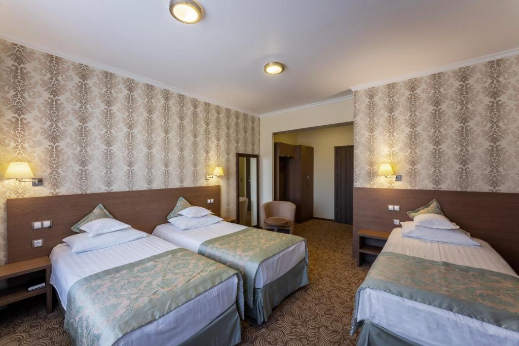 Postel nebo postele na pokoji v ubytování Hotel Stil