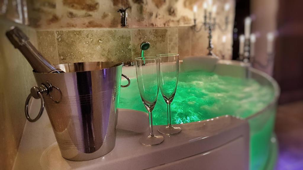 two champagne glasses in a tub of green water at Le Domaine Saint Martin in Flassans-sur-Issole