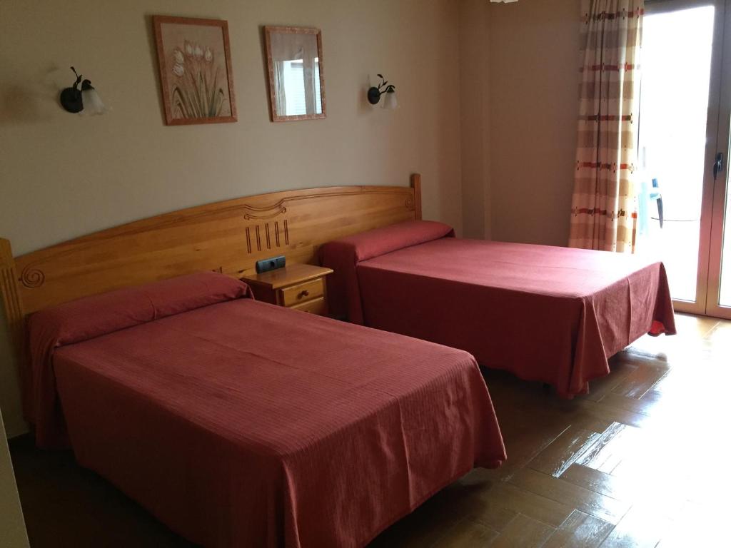 Posteľ alebo postele v izbe v ubytovaní Hostal Ana