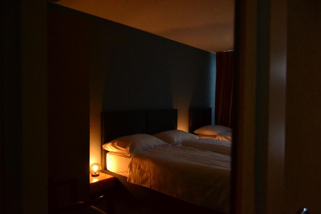 Postel nebo postele na pokoji v ubytování Hotel Les Rives Du Doubs
