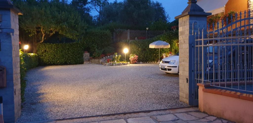 a driveway with a car parked in front of a gate at Bargoncello in Riccò del Golfo di Spezia