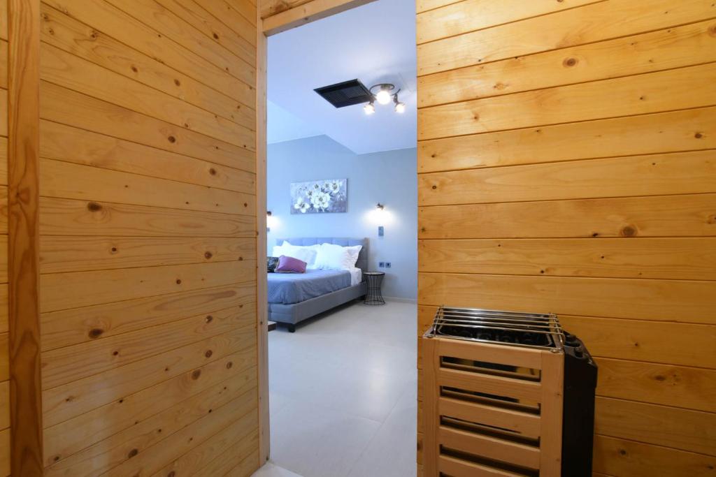 a room with a wooden wall with a stove in it at Orion Eco Suites in Karteros