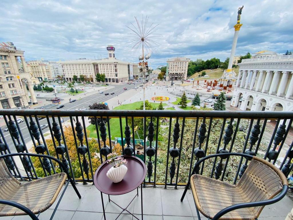 a balcony with chairs and a view of a city at Amazing view of Independence square in Kyiv