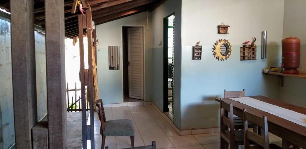 a dining room with a table and chairs at Pousada Sírius in São Roque de Minas