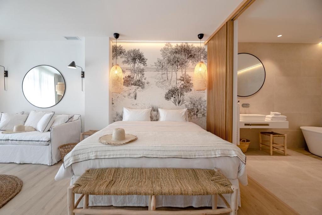 a bedroom with a large bed and a bath room at Les Suites de Collioure in Collioure