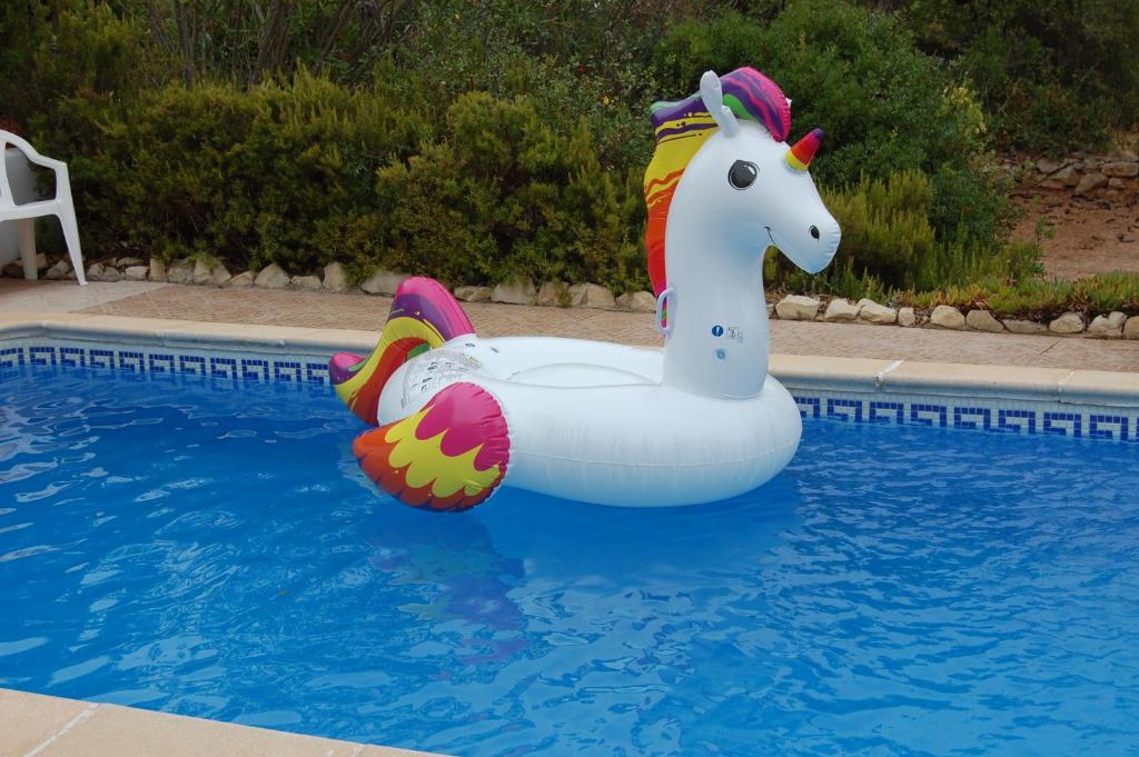 a inflatable unicorn float in a swimming pool at Casa dos Amigos-cottage for 6 persons in Estói