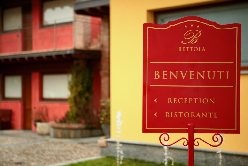 a red sign in front of a building at Hotel Ristorante La Bettola in Urgnano