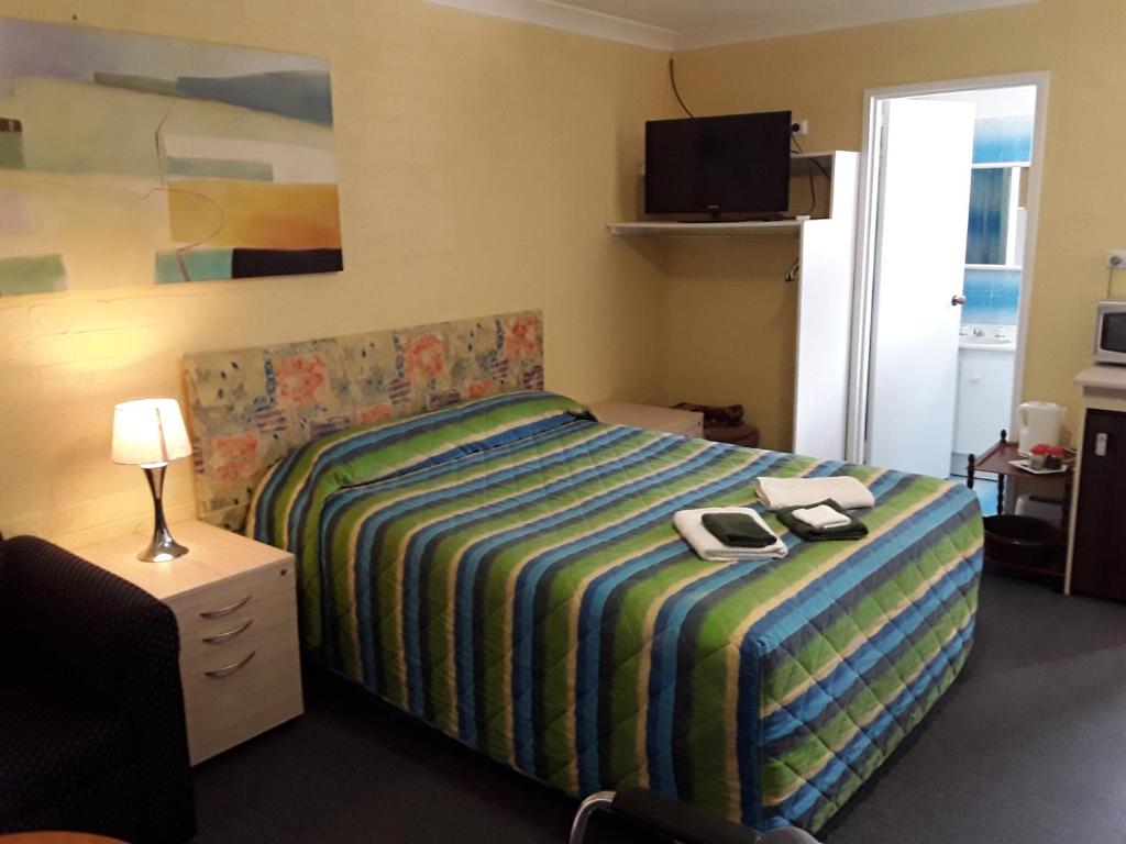 Postel nebo postele na pokoji v ubytování Snowdream Motel