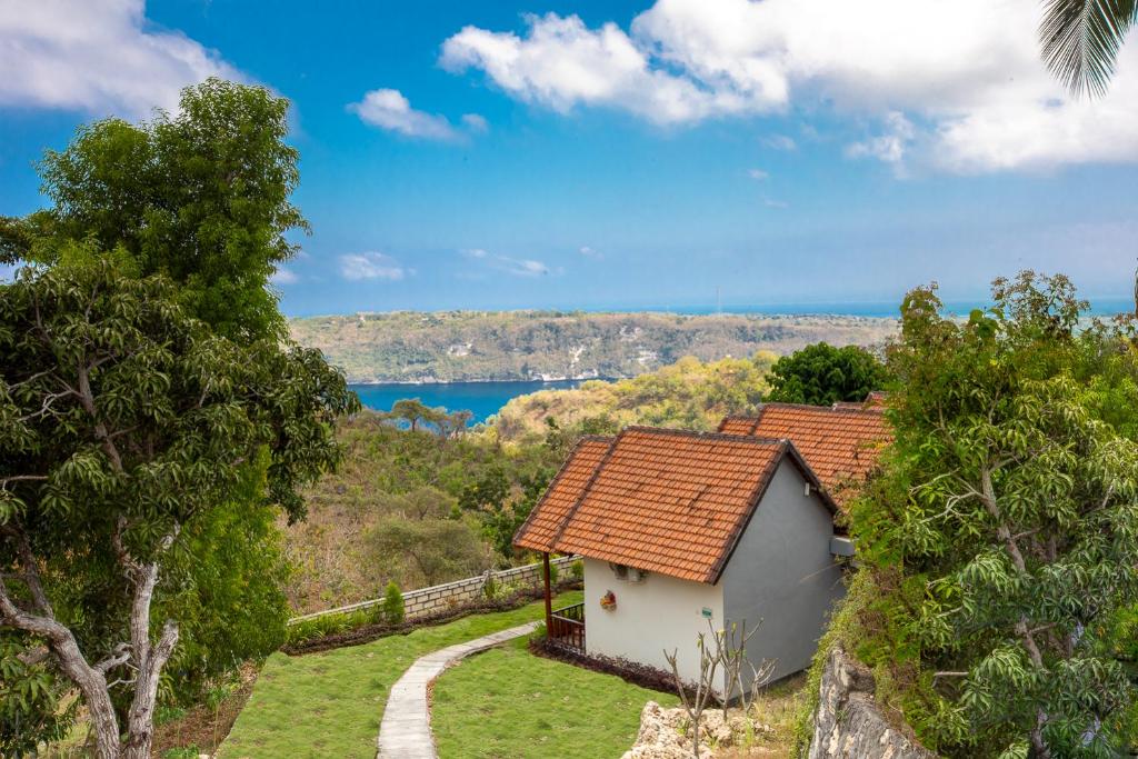 une maison sur une colline avec vue sur l'eau dans l'établissement Abian Selumbung Bungalow, à Nusa Penida