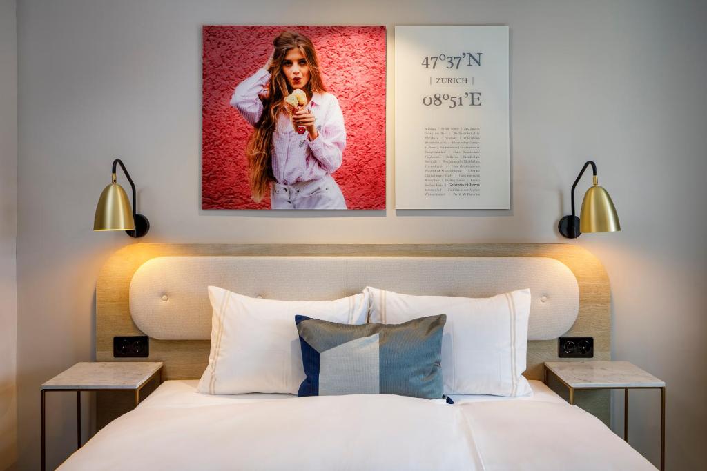 a bedroom with a bed with a poster on the wall at Hotel Felix in Zurich